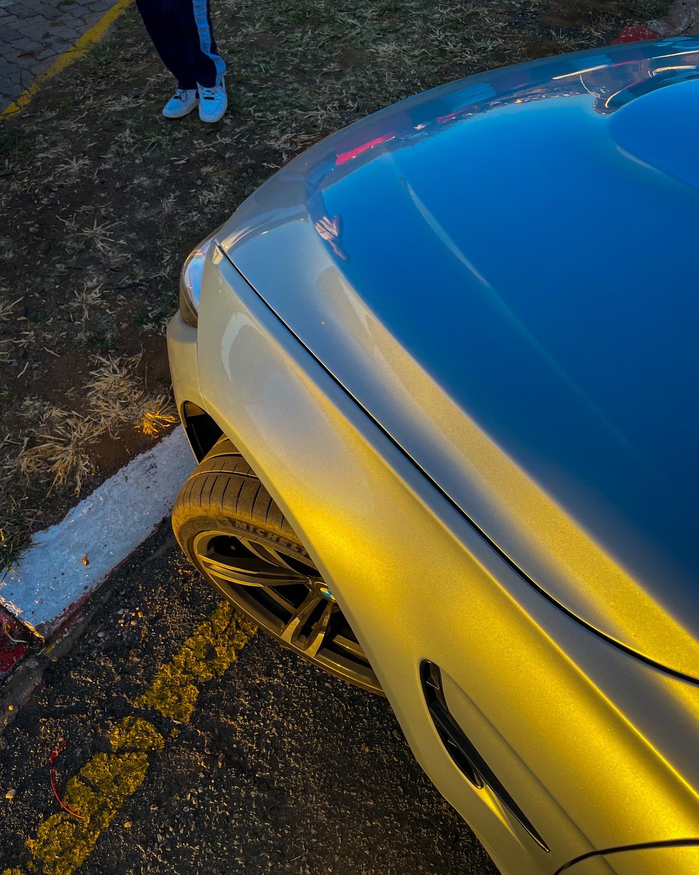 Enthusiasts gathered around an engine bay during a meet