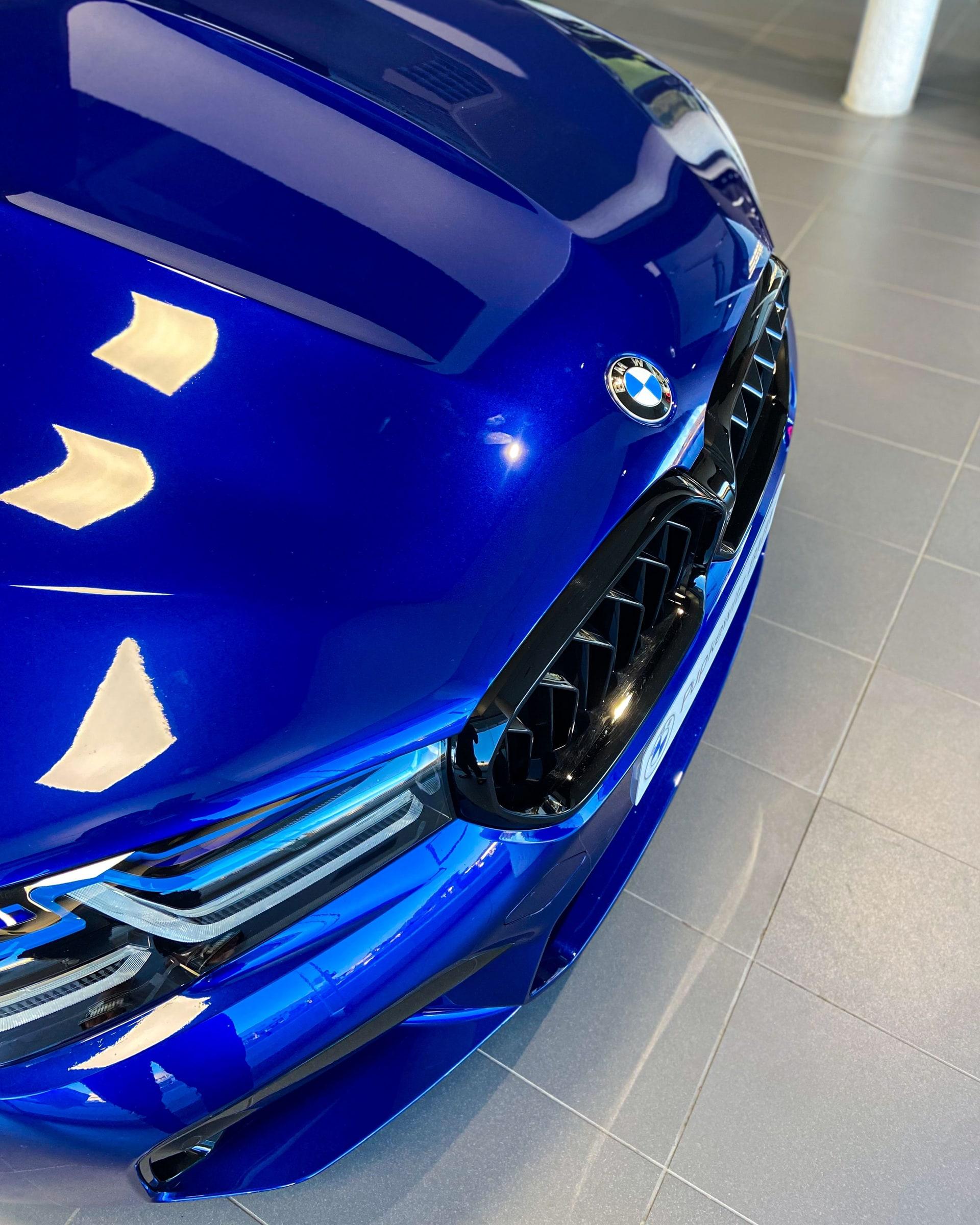 Reflections across the bonnet of a blue BMW M5
